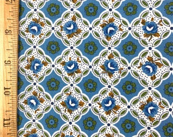 May include: Blue and white floral fabric with a repeating pattern of blue flowers and green leaves. The fabric has a white background with a blue grid pattern.