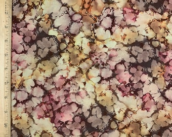 May include: A fabric with a brown, beige, and pink tie-dye pattern. The pattern resembles a marbleized effect with irregular shapes and swirls.