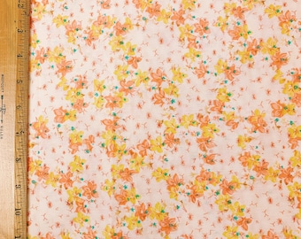 May include: A white fabric with a repeating pattern of small orange and yellow flowers. The fabric has a subtle texture and a light, airy feel.