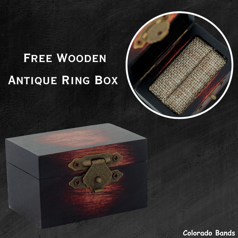 May include: A dark wood ring box with a hinged lid and a brass latch. The box has a distressed finish and is lined with a brown fabric. The text "FREE WOODEN ANTIQUE RING BOX" is visible in the image.