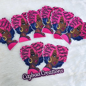 May include: A collection of pink and blue patches featuring a stylized illustration of a woman with pink hair and gold hoop earrings. The patches have text that reads "Queen, Gifted, Talented, Love, Girl, Smart, Beauty, Powerful, Strong, Loyal". The brand name "Cazbaa Creations" is also visible.