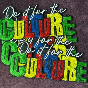 May include: A stack of embroidered patches featuring the text Do it for the CULTURE in a bold, blocky font. The letters are covered in vibrant green, yellow, red, and blue sequins, with the phrase Do it for the in white cursive script above.