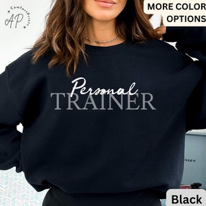 May include: Black sweatshirt with the text "Personal TRAINER" in white lettering.