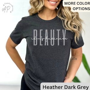 May include: Heather dark grey t-shirt with the text "Beauty is my business" in white lettering.