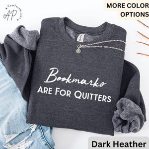 May include: Dark heather grey sweatshirt with the text "Bookmarks are for quitters" in white.