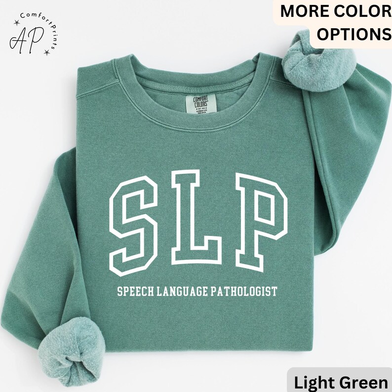 May include: Light green sweatshirt with the text "SLP" in white outlined letters and the words "Speech Language Pathologist" below.