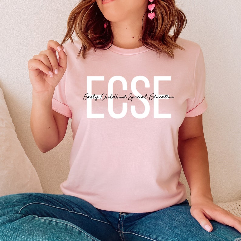 May include: A pink t-shirt with the text "ECSE Early Childhood Special Education" in white letters.