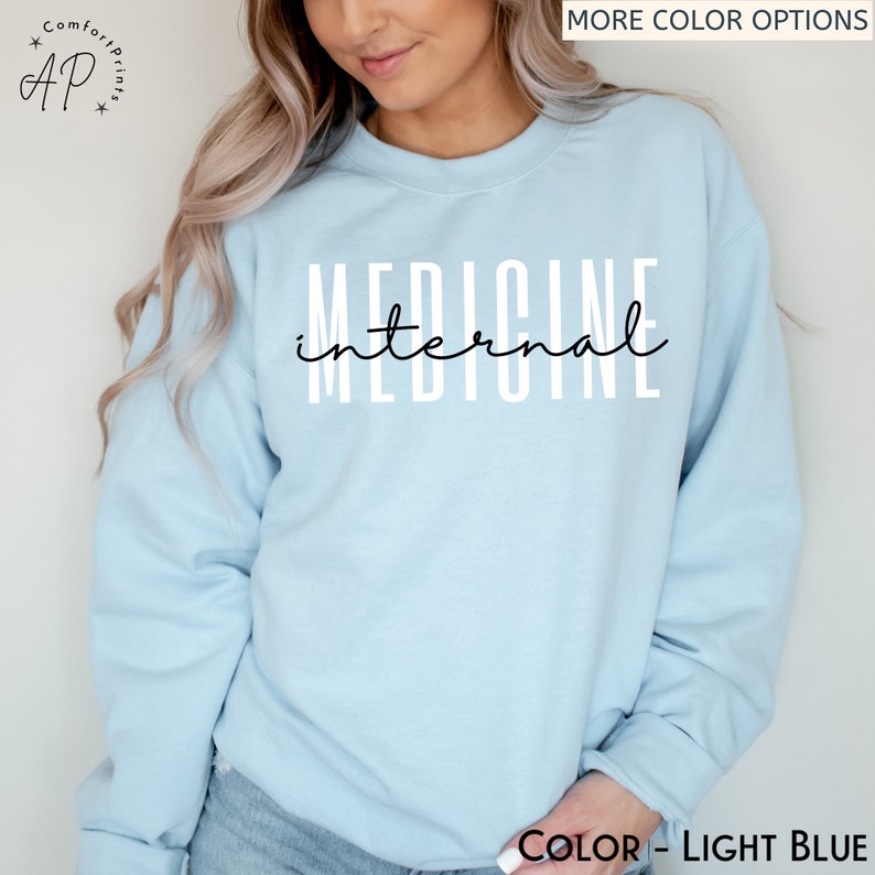 May include: Light blue sweatshirt with the text "INTERNAL MEDICINE" printed in black on the front.
