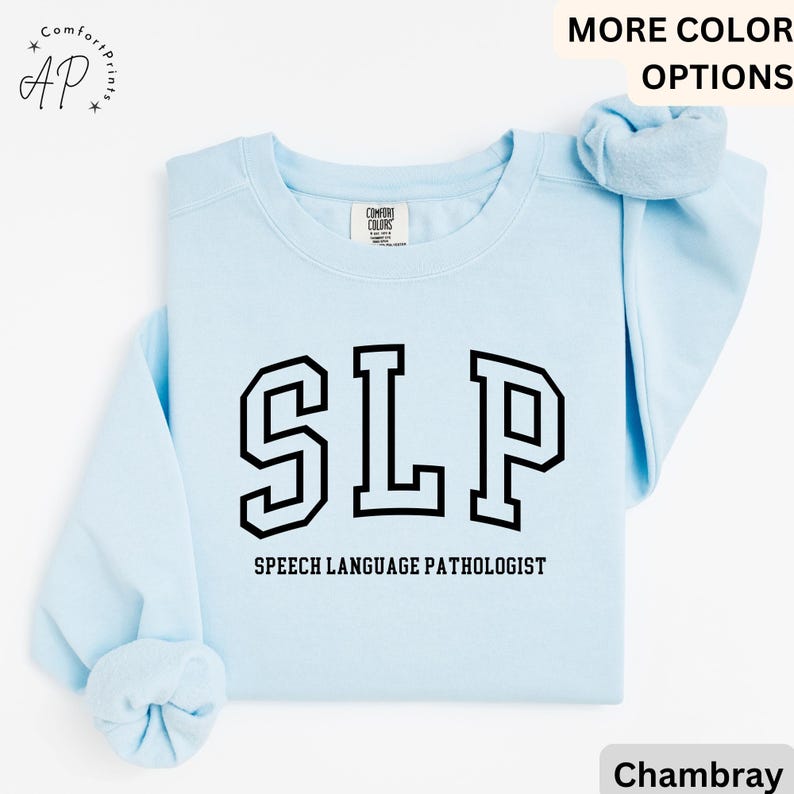 May include: Light blue sweatshirt with the text "SLP" in black outlined letters. Below the text is "Speech Language Pathologist".