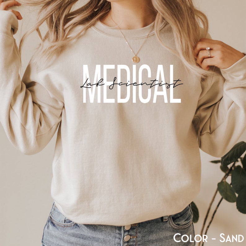 May include: A sand-colored sweatshirt with the text "MEDICAL Lab Scientist" printed in white.