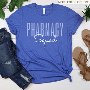 May include: A royal blue t-shirt with the text "Pharmacy Squad" in white. The text is in a bold, blocky font with the word "Squad" in a cursive font.