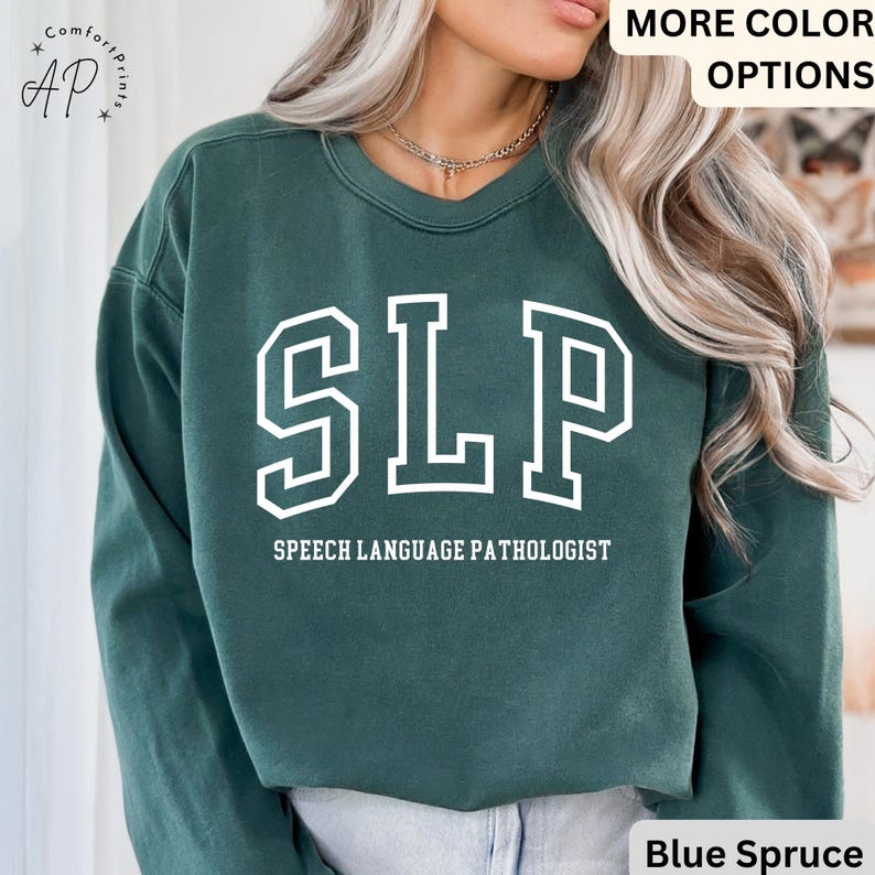 May include: A dark green sweatshirt with the text "SLP" in white, outlined in black, and the words "Speech Language Pathologist" in white below. The sweatshirt is made of a soft, comfortable material and has a relaxed fit.