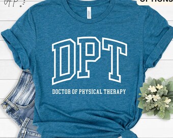 May include: A teal blue t-shirt with white text that reads "DPT" and "DOCTOR OF PHYSICAL THERAPY".