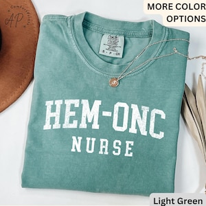 May include: Light green t-shirt with the text "HEM-ONC NURSE" in white. The shirt is made of a soft, comfortable material.