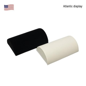 May include: Two display stands, one black and one off-white, are shown against a white background. The stands are cylindrical with a flat base and a curved top. The text "Atlantic display" is visible.