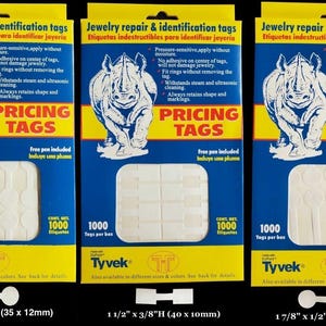 May include: Three boxes of Tyvek pricing tags for jewelry repair and identification. Each box contains 1000 tags. The packaging is blue and yellow with a rhino illustration and text that reads "PRICING TAGS". The tags come in three sizes: 1 3/8" x 1/2", 1 1/2" x 3/8", and 1 7/8" x 1/2".