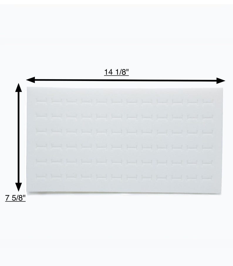 May include: A white rectangular ring display tray with multiple ring slots. The tray measures 35.9 cm long and 19.4 cm wide. The tray is designed to hold and showcase rings.