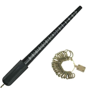 May include: A black ring sizer tool with white markings and a set of gold-colored ring sizer gauges. The ring sizer tool is tapered and has a handle. The ring sizer gauges are attached to a small metal plate.