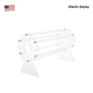 May include: A clear acrylic display stand with a cylindrical base and five horizontal bars. The stand is designed to hold and display items like bracelets or necklaces.
