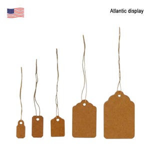 May include: Five brown paper gift tags with string attached. The tags are different sizes and have rounded edges. The text "Atlantic display" is in the top right corner of the image.