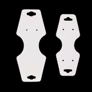 May include: Two white earring display cards with a teardrop shape, each featuring a hole at the top for hanging and two smaller holes for earrings. The cards have a unique hourglass-like design with a cutout in the middle.
