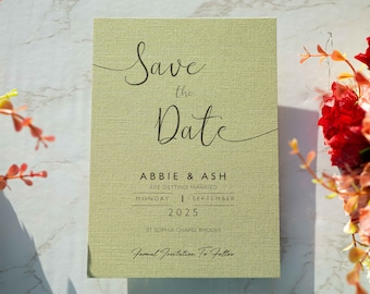 May include: A green save the date card with the text "Save the Date" in cursive script. The card also includes the names "Abbie & Ash" and the date "Monday, September 20, 2025". The location is listed as "St. Sophia Chapel Rhodes".