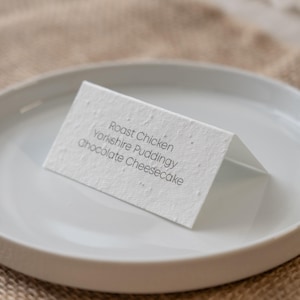plantable wedding name cards, seeded place cards, eco wedding place cards, biodegradable name cards, sustainable wedding stationery, wildflower seed name cards, personalised seed paper place cards, zero waste wedding name tags, plantable paper wedding tags, eco friendly wedding name cards, recycled paper place cards, seed paper guest name cards, environmentally friendly wedding cards, green wedding place settings, custom plantable name cards, seed paper name tags wedding, eco conscious wedding