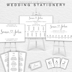 May include: Wedding stationery set with a white background and black text. The set includes a welcome sign, a seating chart, an order of the day, table numbers, and menus. The text on the signs includes the names "Sonia" and "John" and the date "11 November 2023".