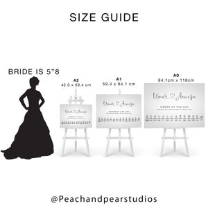May include: A size guide for wedding signage, showing a silhouette of a bride standing next to three different sizes of easel stands with wedding signs. The signs are white with gray text and a heart design. The signs read "Umar & Aneesa" and "Order of the Day". The sizes are A0 (84.1 cm x 118 cm), A1 (59.4 cm x 84.1 cm), and A2 (42.0 cm x 59.4 cm).