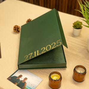 green gift box with photo album