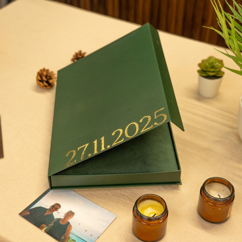 green gift box with photo album