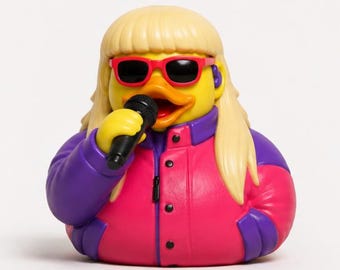 May include: A yellow rubber duck figurine styled with long blonde hair, red-framed sunglasses, and a purple and hot pink jacket. The duck holds a black microphone in its wing and wears a small purple earpiece, presenting a colorful, detailed design.