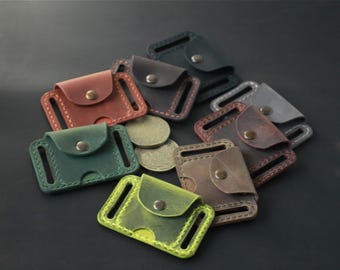 May include: A collection of small leather belt pouches in various colors including green, lime, brown, red, and black. Each rectangular pouch features a flap with a metal snap button closure, stitched edges, and two side slots for belt attachment.