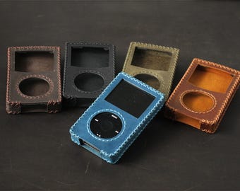 May include: Five rectangular protective cases for portable media players, each featuring a cutout for the screen and click wheel, stitched edges, and available in blue, black, dark brown, light brown, and olive green leather-like material.