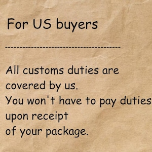 May include: A light brown, textured paper background featuring black text that reads: For US buyers. All customs duties are covered by us. You won't have to pay duties upon receipt of your package. The text is presented in a simple, sans-serif font.