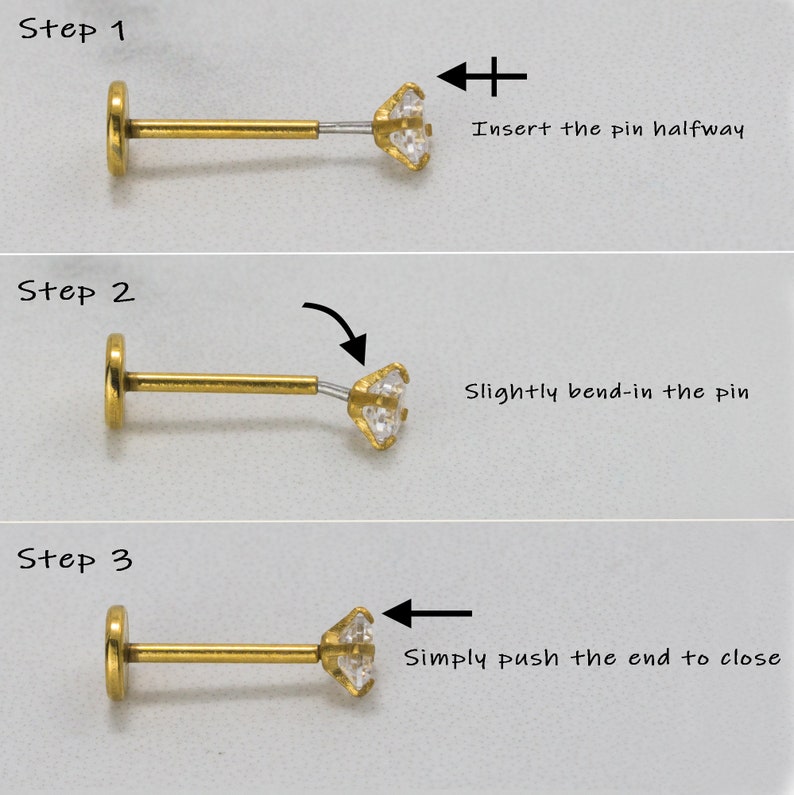 May include: A three-step guide on how to insert a gold body piercing with a clear gem. Step 1: Insert the pin halfway. Step 2: Slightly bend-in the pin. Step 3: Simply push the end to close.