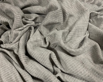 May include: Close-up of a gray ribbed fabric with a soft, textured surface.