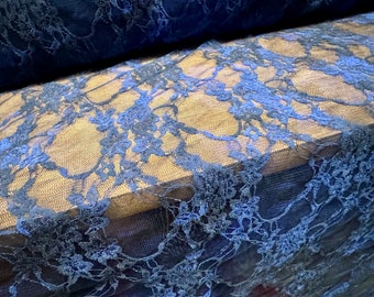 May include: Blue lace fabric with a floral pattern. The lace is delicate and has a soft, flowing texture.
