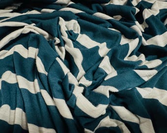 May include: Teal and white striped fabric with a soft, textured feel. The fabric is folded and draped, showcasing the striped pattern.