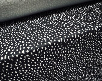 May include: Black fabric with a white polka dot pattern. The fabric is folded in half, showing the pattern on both sides.