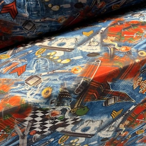 May include: A blue and red fabric with a repeating pattern of denim, zippers, safety pins, and plaid. The fabric has a distressed look and is perfect for crafting projects.
