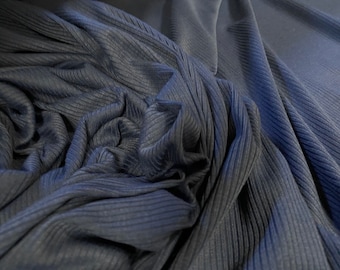 May include: Close-up of a dark blue ribbed fabric. The fabric is soft and has a subtle sheen.