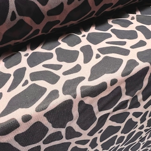 May include: Close-up of a pink and black patterned fabric with a mesh texture. The pattern resembles a giraffe print.