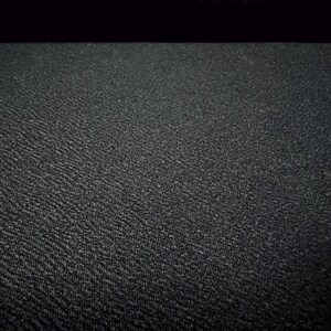 May include: A close-up of a black textured surface. The surface has a subtle pattern of small raised dots.