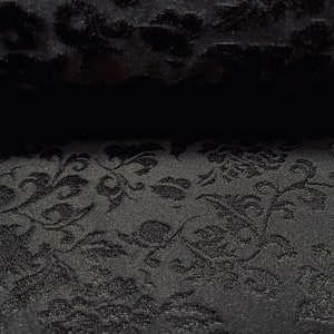 May include: Black fabric with a raised floral pattern. The fabric has a subtle sheen and a soft texture.