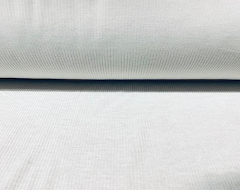 May include: White ribbed fabric with a smooth texture. The fabric is folded in half, showing the ribbed pattern on both sides.