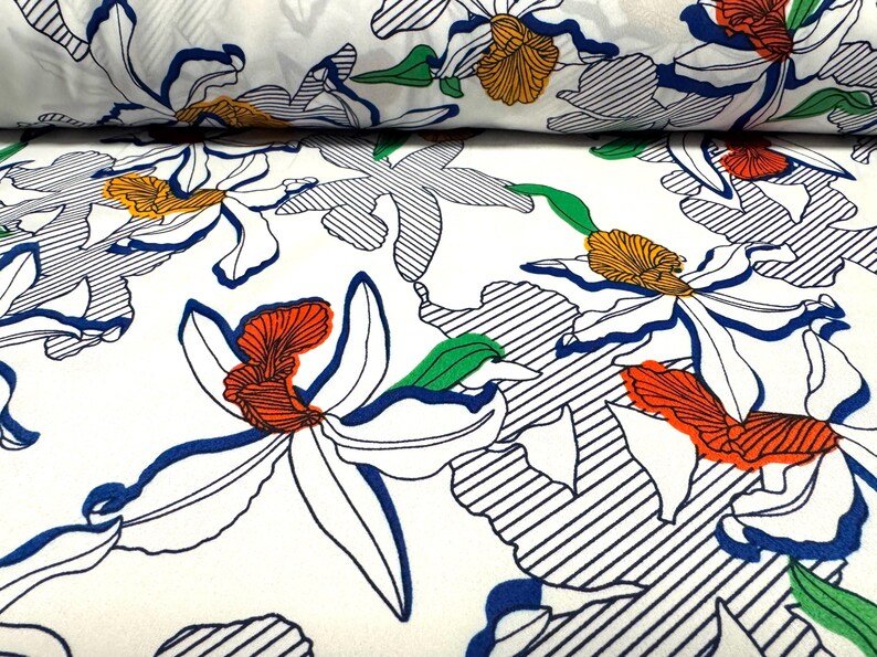 May include: White fabric with a repeating pattern of blue, green, orange, and red stylized flowers. The flowers are outlined in black and have a striped background.