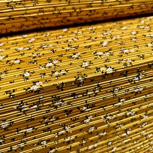 Stretch plissé pleated satin dress fabric, per metre - ditsy flower print - yellow gold