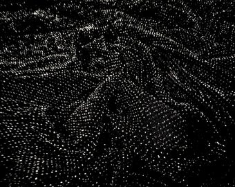 May include: Black fabric with a white, textured pattern. The fabric is wrinkled and has a soft, flowing texture.