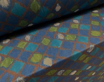 May include: Blue fabric with a repeating pattern of green, blue, and white squares. The squares are painted on a brown background.